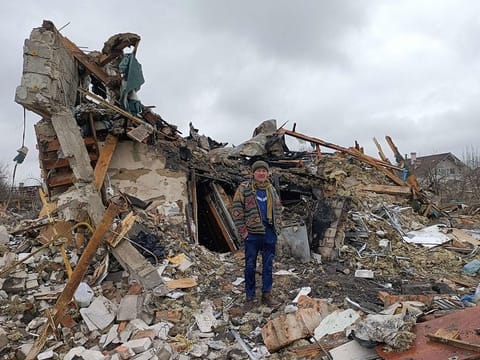 A Ukrainian man stands in the rubble in Zhytomyr, following a Russian bombing. 