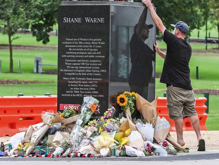 A mourner pays respects to Shane Warne outside Melbourne Cricket Ground 