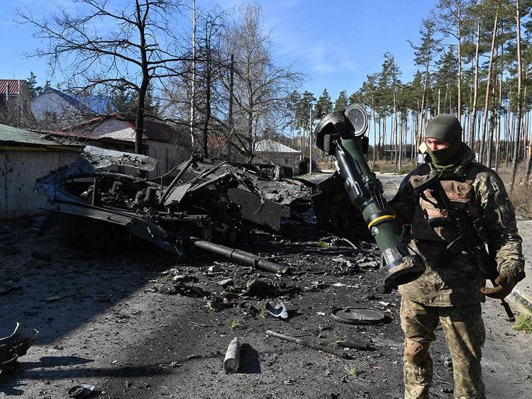 A Ukrainian soldier holds a Next Generation Light Anti-tank Weapon (NLAW) that was used to destroy a Russian armoured personal carrier (APC) in Irpin, north of Kyiv, on March 12, 2022.  