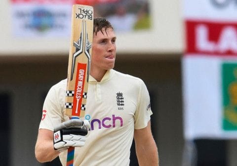 Zak Crawley of England celebrates his century during the 4th day of the 1st Test between England and West Indies at Vivian Richards Cricket Stadium in North Sound, Antigua and Barbuda.