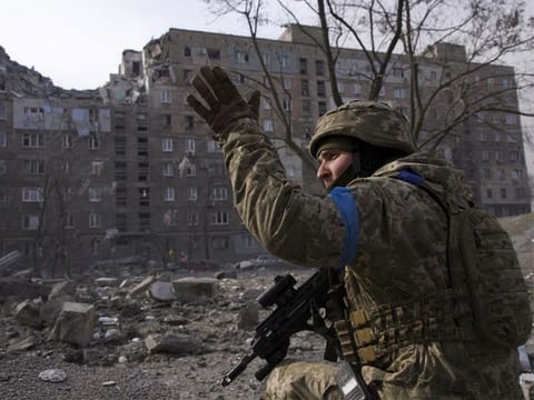 A Ukrainian serviceman guards his position in Mariupol, Ukraine, Saturday, March 12, 2022.