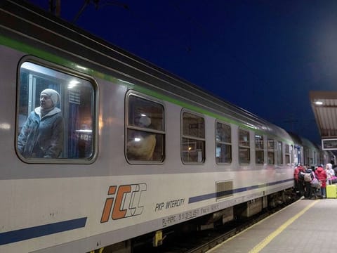 File photo: Ukrainian refugees embark a train bound to Warsaw, at the Przemysl train station, southeastern Poland, on March 11, 2022. 