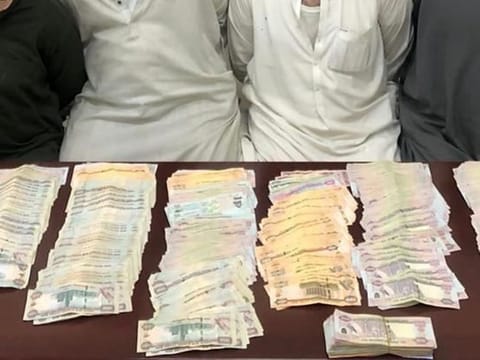 Gang members with the stolen cash. 