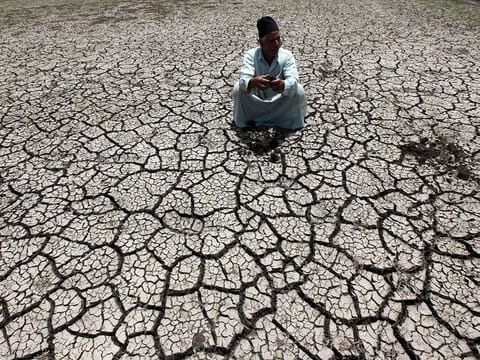 An Egyptian farmer on a parched land in a drought-hit farm in Al-Dakahlya. Climate scientists warned recently that the likely return of the El Nino weather pattern in the Pacific later this year could cause global temperatures to temporarily surge 1.5C above their pre-industrial average in 2024.