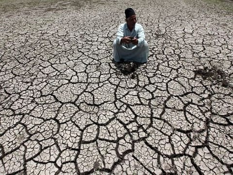 An Egyptian farmer on a parched land in a drought-hit farm in Al-Dakahlya. Climate scientists warned recently that the likely return of the El Nino weather pattern in the Pacific later this year could cause global temperatures to temporarily surge 1.5C above their pre-industrial average in 2024.