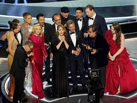 The cast and crew of "CODA" accept the award for best picture at the Oscars on Sunday, March 27, 2022, at the Dolby Theatre in Los Angeles. 