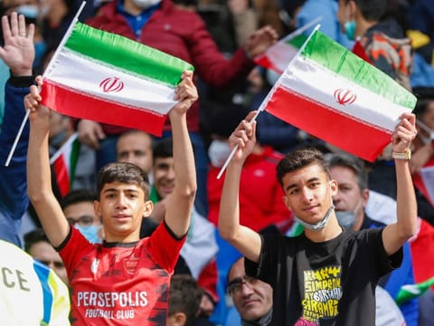 Iran supporters wave the national flag during the 2022 Qatar World Cup Asian Qualifiers football match between Iran and Lebanon, at the Imam Reza Stadium in the city of Mashhad, on March 29, 2022. 