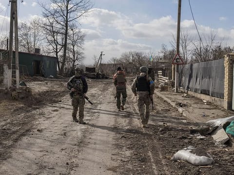 Ukranian servicemen walk through the village of Lukyanivka outside Kyiv, as Russia's invasion of Ukraine continues, Ukraine.