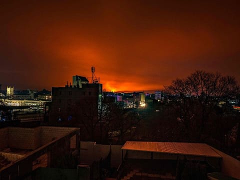 This general view taken on March 30, 2022 shows fire and smoke lighting up the night sky, east of Kharkiv. 