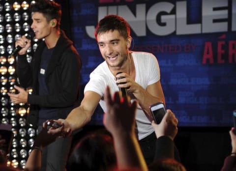 The Wanted's Tom Parker reaches out to the crowd during a performance at Z100's Jingle Ball 2012 kickoff event presented by Aeropostale on Friday, October 19, 2012 in New York.