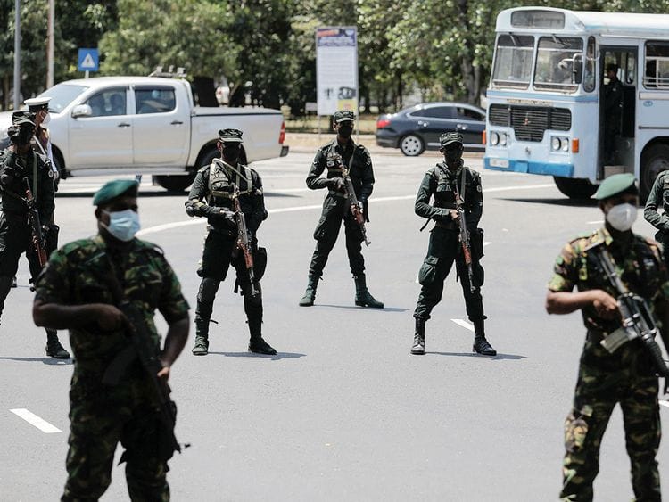 Sri Lankan army soldiers stand guard 
