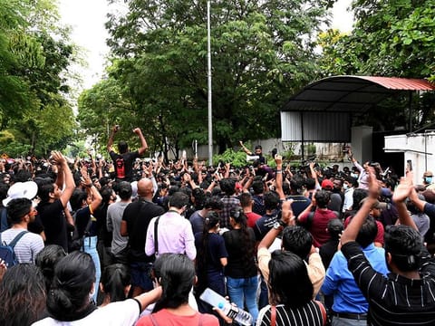 Demonstrators take part in a protest against the surge of prices and shortage of fuel and other essential commodities at the entrance of the Sri Lanka prime minister m]Mahinda Rajapaksa residence in Colombo on April 5, 2022.  