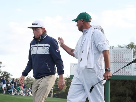 Brutal conditions: Cameron Smith of Australia (left) and caddie Sam Pinfold walk off the 18th green after finishing their third round during the Masters at Augusta National Golf Club on Saturday.