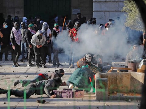 Palestinian demonstrators clash with Israeli police at Jerusalem's Al Aqsa mosque compound on April 15, 2022.  