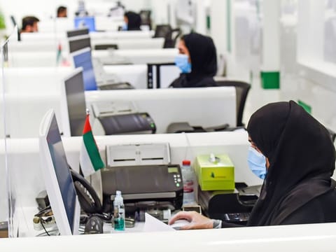 Amer centre staff processing visa applications in Dubai. 