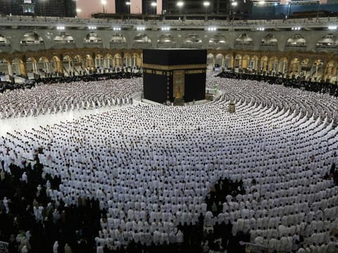 The faithful pray around the Kaaba, Islam's holiest shrine, at the Grand Mosque complex in the Saudi city of Mecca on April 9, 2022.  