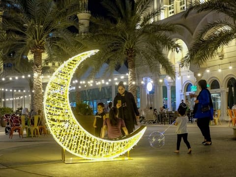 Al Qasba in Sharjah decorated with Ramadan lights as shoppers set out to buy Eid gifts for family and friends. 