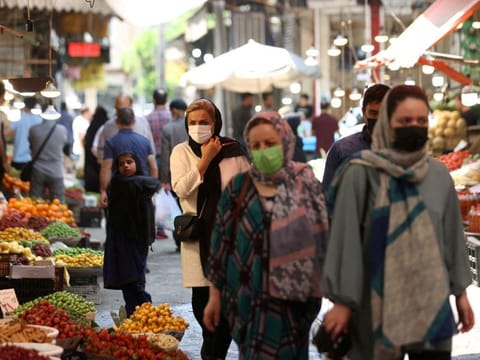 Iranians walk in a market in Tehran, Iran May 1, 2022. Clerical rulers may be wary of simmering disenchantment at home, according to a former Iranian government official.