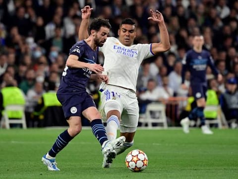 Manchester City's Portuguese midfielder Bernardo Silva (left) vies with Real Madrid's Brazilian midfielder Casemiro during the UEFA Champions League semi-final second leg at the Santiago Bernabeu stadium in Madrid.