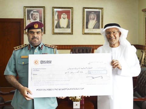 Yousef Sultan Al Ajmani (right) and Brigadier General Khalid Mohammad Al Nuaimi with the donation cheque 