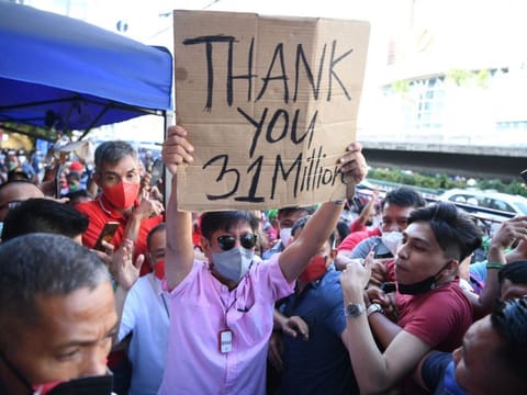 Presidential candidate Ferdinand Marcos Jr is mobbed by his supporters as he arrives at the campaign headquarters in Manila on May 11, 2022.  