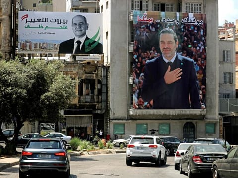 A Lebanese parliamentary elections campaign billboard for candidate Melhem Khalaf (left) hangs on a building next to one of former PM Saad Hariri, in Beirut. Hariri’s January 2022 decision to boycott the upcoming elections has shifted focus back to Lebanon’s Sunnis, away from Maronite Christians and their politics.