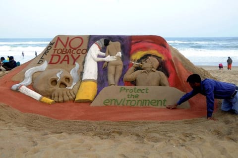 Artist Manas Sahoo creates a sand sculpture to spread awareness on the occasion of "World No Tobacco Day", on the Puri beach in India's Odisha state.