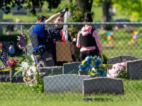 Law enforcement examine a bloody garment while working at the scene of a shooting Thursday, June 2, 2022 at Graceland Cemetery in Racine, Law enforcement examine a bloody garment while working at the scene of a shooting Thursday, June 2, 2022 at Graceland Cemetery in Racine, Wisconsin.