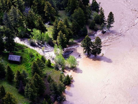 This aerial photo provided by the National Park Service shows the Lower Blacktail Patrol Cabin washed away in Yellowstone National Park on Monday, June 13, 2022. 