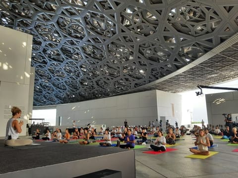 Residents from all walks of life gathered under the dome of the museum for the community yoga event