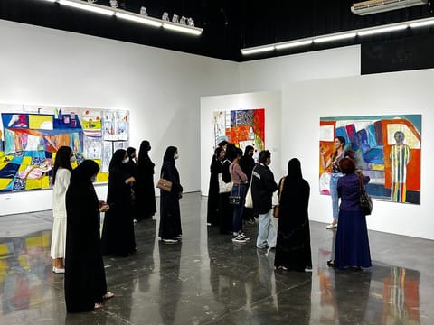 Students view NFT art at Zawyeh Gallery at Al Serkal Avenue as part of the Abu Dhabi programme