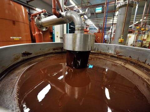 This file photograph taken on July 8, 2013, shows hot chocolate before being moulded at the Barry Callebaut chocolate factory in Wieze, eastern Flanders. 
