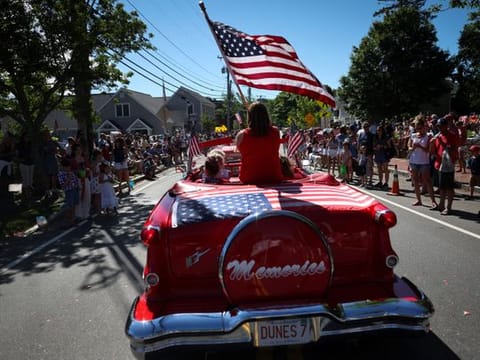 The American flag on an antique car during the annual Fourth of July parade in Barnstable Village, on Cape Cod, Massachusetts, US, on July 4, 2022. The flag is the flag, and it encompasses the whole American idea. 