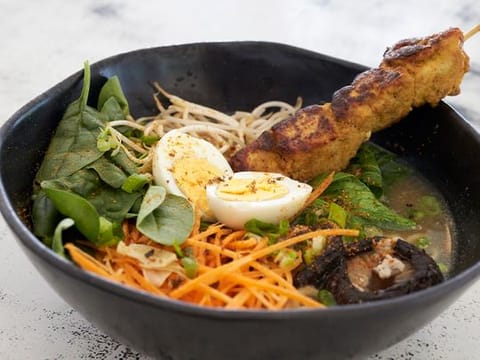 Watch how to make spicy Japanese chicken ramen with chicken skewers and soft boiled egg