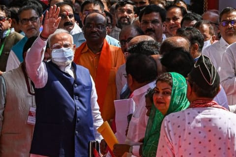 Indian Prime Minister Narendra Modi (L) gestures after casting his vote to elect the next Indian president at Parliament House in New Delhi on July 18, 2022.
