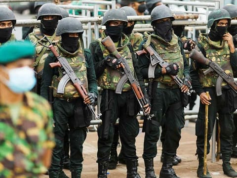 Security personnel stand guard near the Presidential Secretariat after a raid on an anti-government protest camp early on Friday, in Colombo. 