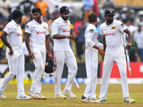 Sri Lanka's left-arm spinner Prabath Jayasuriya (right) celebrates with teammates after Sri Lanka won by 246 runs at the end the of the second Test match against Pakistan at the Galle International Cricket Stadium in Galle on Thursday.