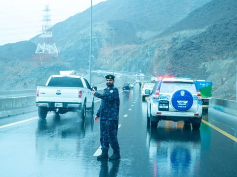 A policeman directs the traffic in rain-affected Fujairah.  