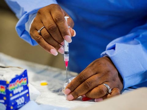 A staff member of the Westchester Medical Center prepares a monkeypox vaccine in a drive-through vaccination point at the Westchester Medical Center in Valhalla, New York. 