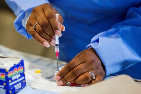 A staff member of the Westchester Medical Centre prepares a monkeypox vaccine in a drive-through monkeypox vaccination point at the Westchester Medical Center in Valhalla, New York, U.S., July 28, 2022.