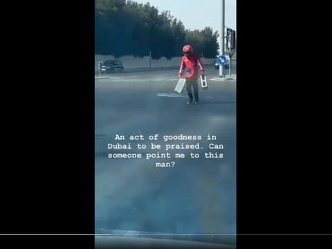 Screengrab from the video shows the rider, whose name is Abdul Ghafoor, picking up concrete blocks from the junction