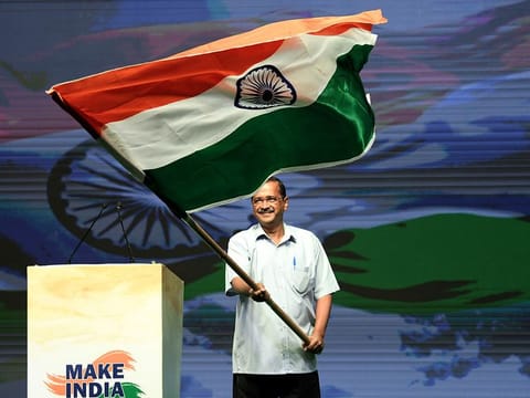 Delhi Chief Minister Arvind Kejriwal waves a national flag during the launch of 'Make India No. 1' mission, at Talkatora Stadium, in New Delhi on Wednesday. (ANI photo)