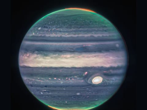 Webb NIRCam composite image of Jupiter from three filters – F360M (red), F212N (yellow-green), and F150W2 (cyan) – and alignment due to the planet’s rotation