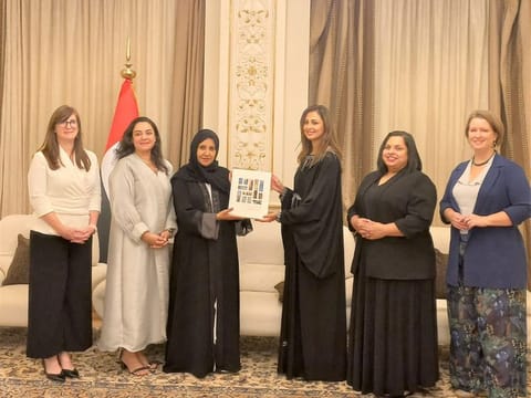 Dr Maitha Al Shamsi receiving book from Rima Al Mokarrab at a ceremony in Abu Dhabi