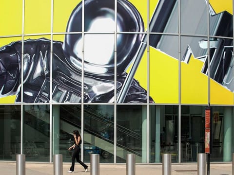 A woman walks by an advertisement for the 2022 MTV Video Music Awards at the Prudential Center in Newark, New Jersey, U.S., August 26, 2022. 