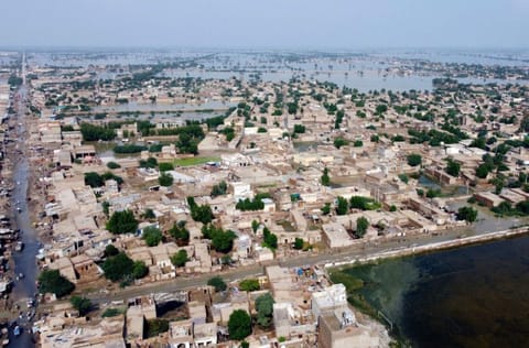 Homes are surrounded by floodwaters in Sohbat Pur city, a district of Pakistan's southwestern Balochistan province, on August 30, 2022. Disaster officials say nearly a half million people in Pakistan are crowded into camps after losing their homes in widespread flooding caused by unprecedented monsoon rains in recent weeks. 
