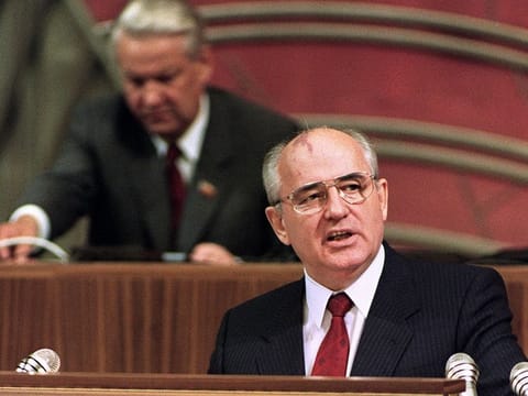 In this file photo taken on June 19, 1990 Soviet President Mikhail Gorbachev (R) addresses the opening session of a conference of Russian communists at the Kremlin while recently elected Russian President Boris Yeltsin stands a desk in the background. 