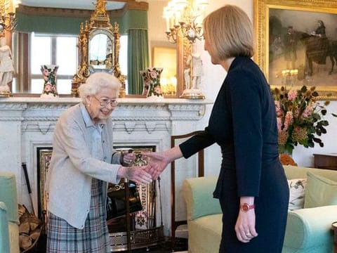 Britain's Queen Elizabeth II, left, welcomes Liz Truss during an audience at Balmoral, Scotland, where she invited the newly elected leader of the Conservative party to become Prime Minister and form a new government, Tuesday, Sept. 6, 2022. 