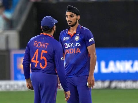 India’s Arshdeep Singh listens to captain Rohit Sharma before bowing his next delivery during the T20 cricket match of Asia Cup at the Dubai International Stadium on September 6, 2022. 