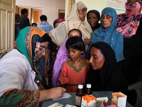 Flood victims receive medical assistance at a medical camp, following rains and floods during the monsoon season, in Manjhand town, in Jamshoro, Pakistan, September 12, 2022. 